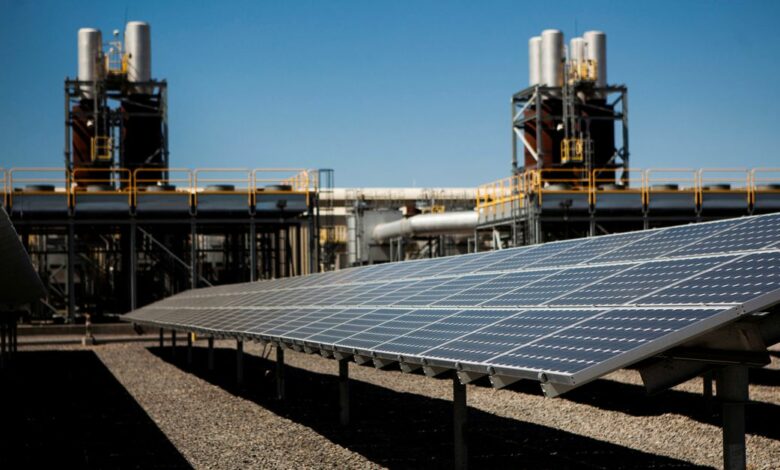 Solar panels are seen in front of a natural gas power plant at the Tahoe-Reno Industrial Center in McCarran, Nevada