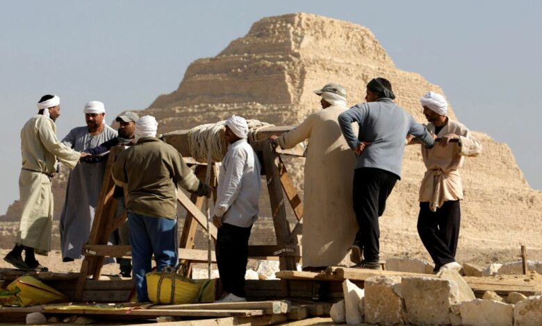 People work at the site after the announcement of the discovery of 4,300-year-old sealed tombs in Egypt