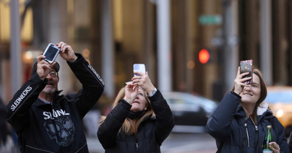 People use smartphones in Manhattan, New York City