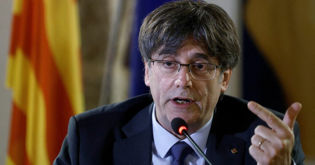 Catalan separatist leader Carles Puigdemont attends a news conference in Alghero