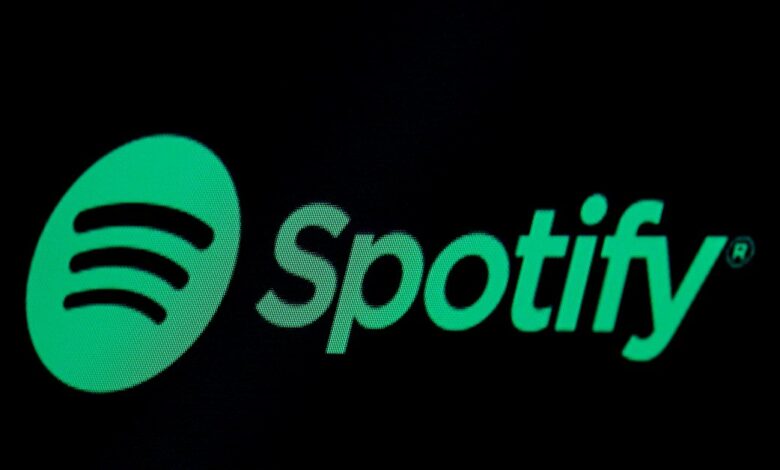 The Spotify logo is displayed on a screen on the floor of the NYSE in New York