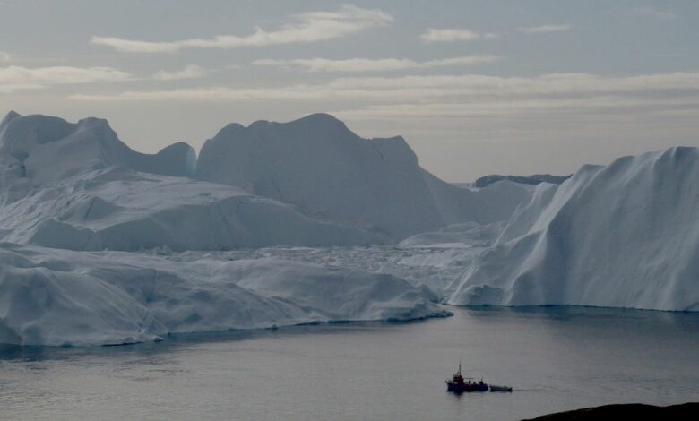 A fishing vessel sails in the ice fjord near Ilulissat