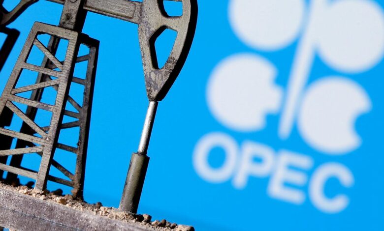 A 3D-printed oil pump jack in front of the OPEC logo in this illustration picture