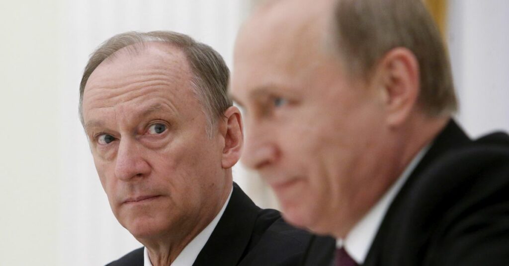 Russian Security Council Secretary Nikolai Patrushev (L) looks at President Vladimir Putin during a meeting with the BRICS countries