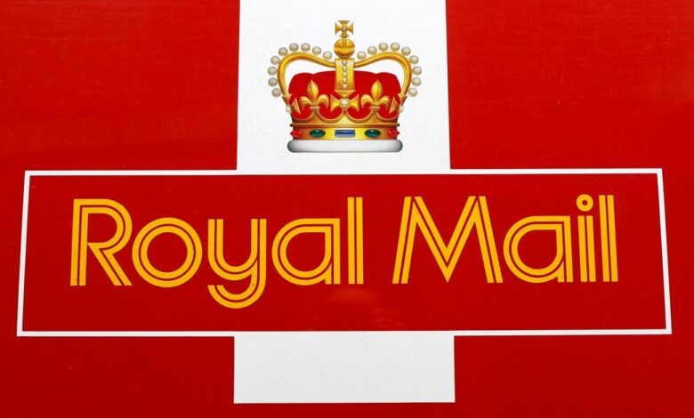 A Royal Mail sign is pictured on a delivery van outside a Post Office, in St Albans