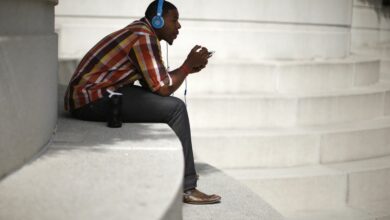 A man with Beats headphones listens to music on an iPhone in Los Angeles