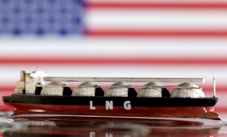 Illustration shows model of LNG tanker and the U.S. flag