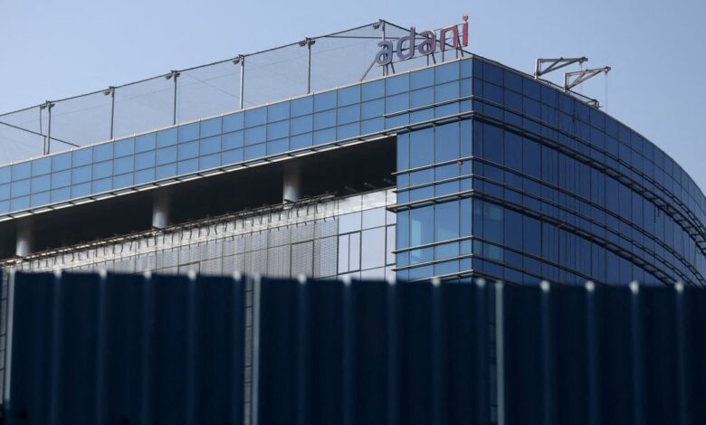 A logo of the Adani Group is seen on a commercial complex in Mumbai