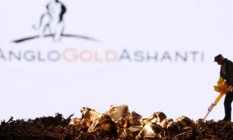 Small toy figure and gold imitation are seen in front of the AngloGold Ashanti logo in this illustration