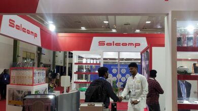 People visit a Salcomp kiosk at an industry event in Chennai