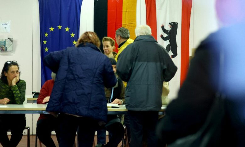 Voters are seen inside a polling station to cast their votes during the repeat state elections in Berlin