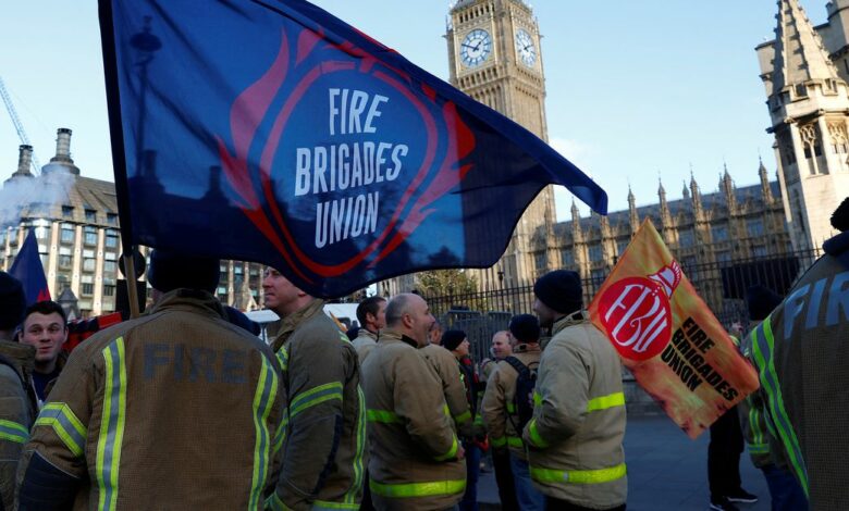 Members of the Fire Brigades Union take part in a rally regarding possible future strike action linked to a pay dispute, in London