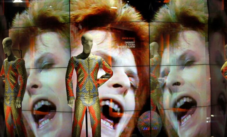 Two suits designed by Freddie Burretti for the Ziggy Stardust tour are displayed during the exhibition