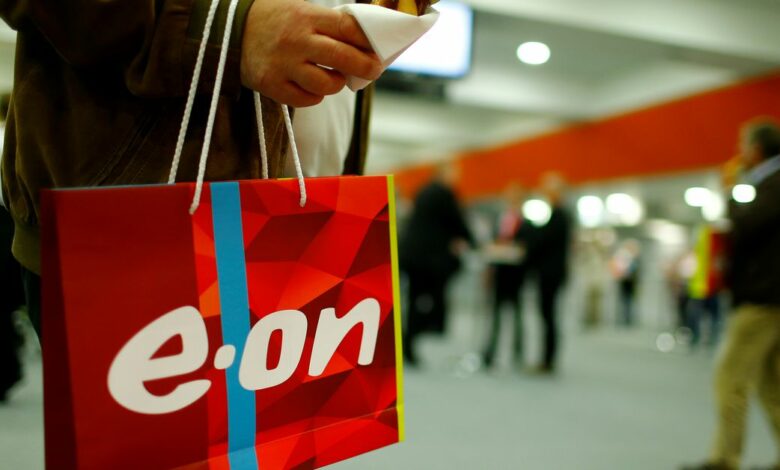 A shareholder carries a bag with the logo of E.ON during the company