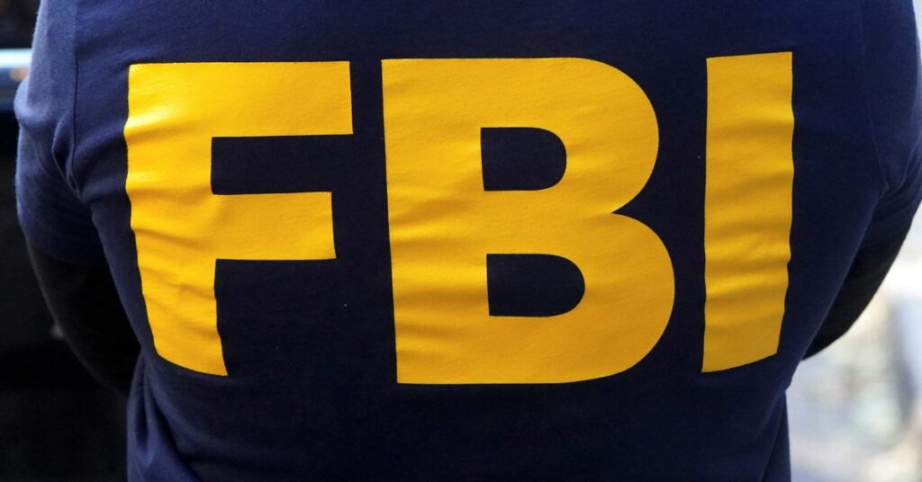 An FBI logo is pictured on an agent