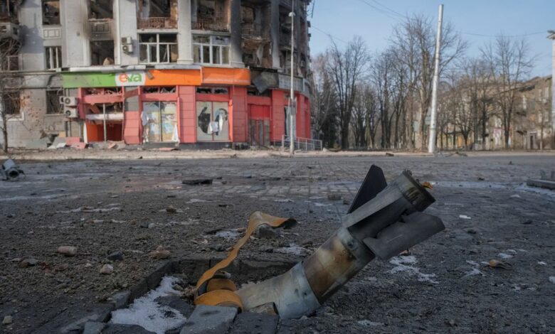 A part of a rocket is seen near a building damaged by a Russian military strike in Bakhmut