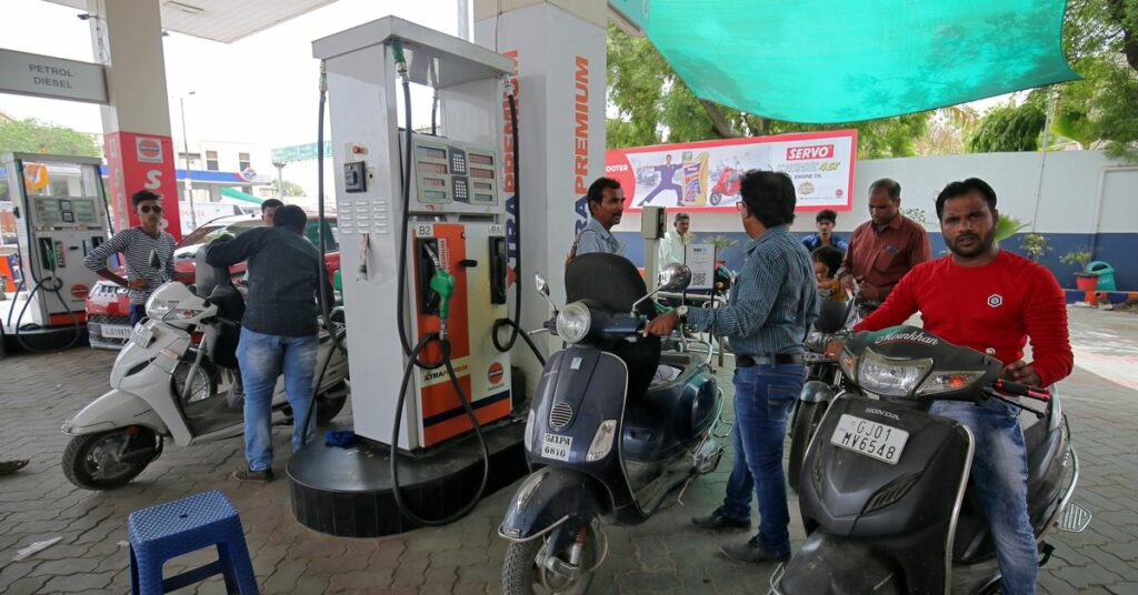 People get their two-wheelers filled with petrol at a fuel station in Ahmedabad