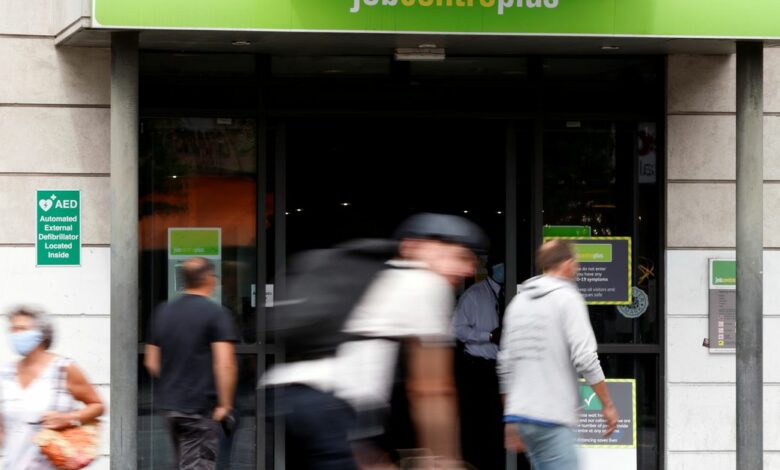 People walk past a branch of Jobcentre Plus, a government run employment support and benefits agency, as the outbreak of the coronavirus disease (COVID-19) continues, in Hackney