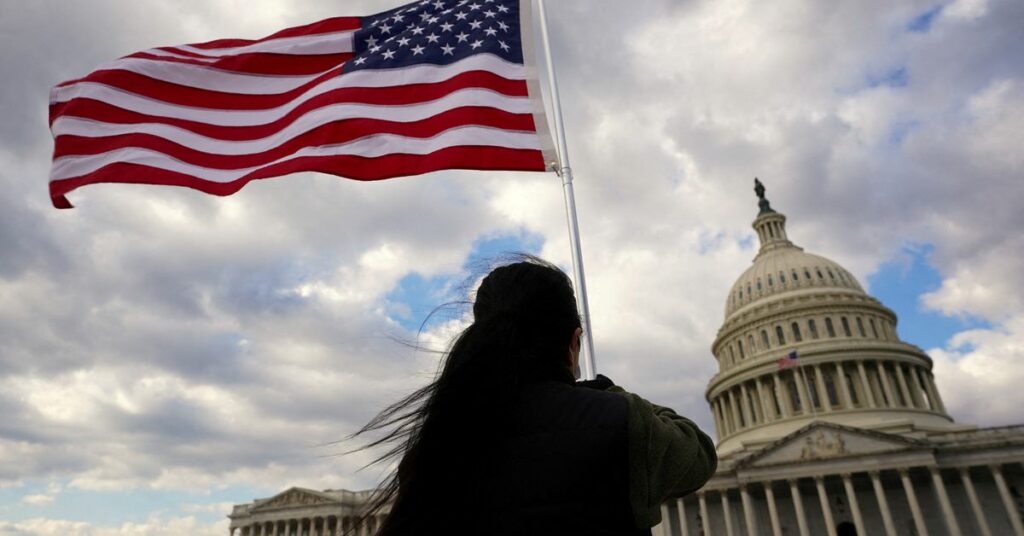 mA flag is held aloft at the U.S. Capitol in Washington