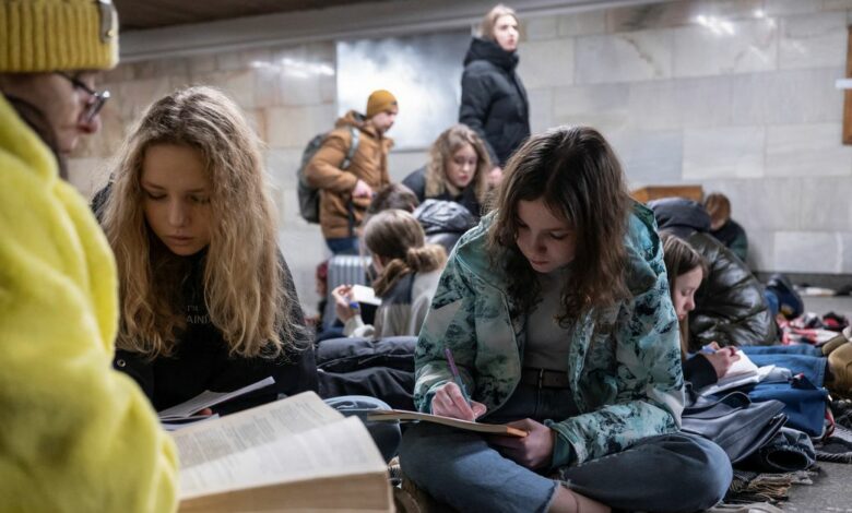 School students attend a lesson as they take shelter inside a metro station during massive Russian missile attacks in Kyiv