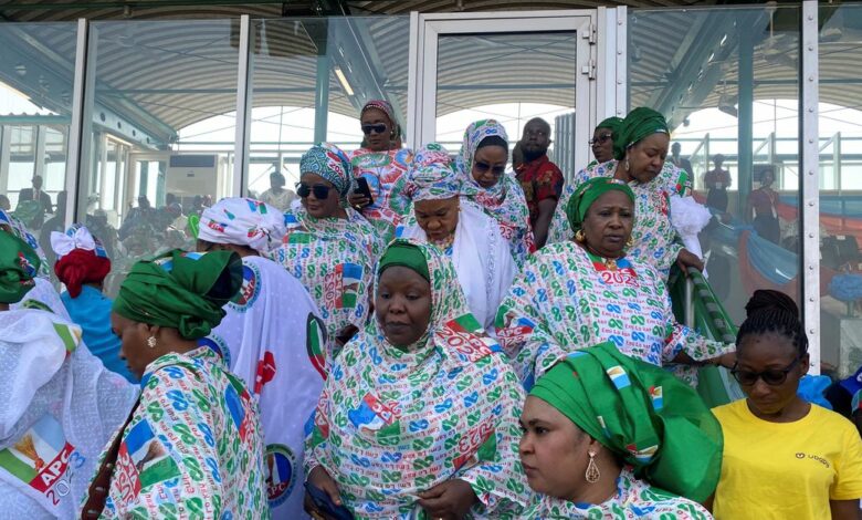 Supporters of All Progressives Congress (APC) wear traditional attire with APC branding during a campaign rally in Abuja