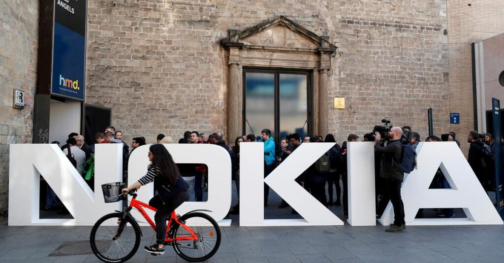 A cyclist rides past a Nokia logo during the Mobile World Congress in Barcelona