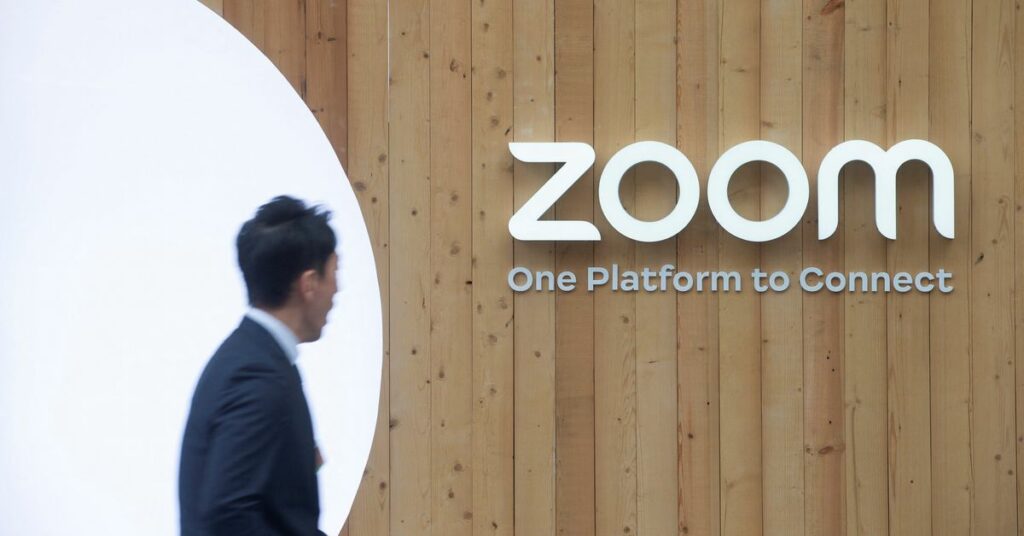 A man walks past a temporary show room of Zoom during the World Economic Forum in Davos