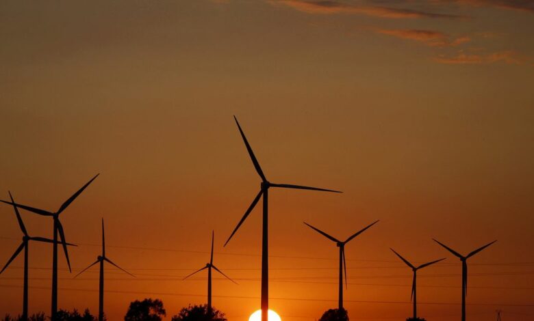 FILE PHOTO: A sunset is seen through a wind farm near Puck