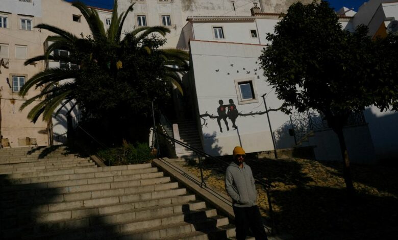 A person walks in Alfama neighbourhood in Lisbon