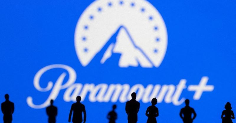 Toy figures of people are seen in front of the displayed Paramount + logo, in this illustration