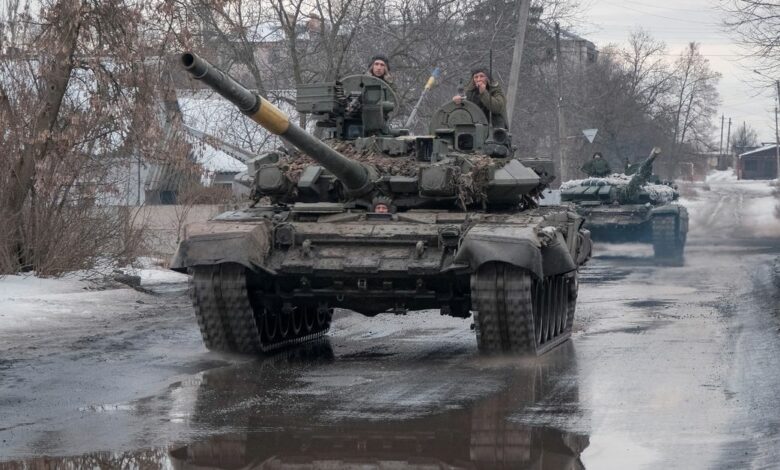 Ukrainian service members ride tanks in Bakhmut