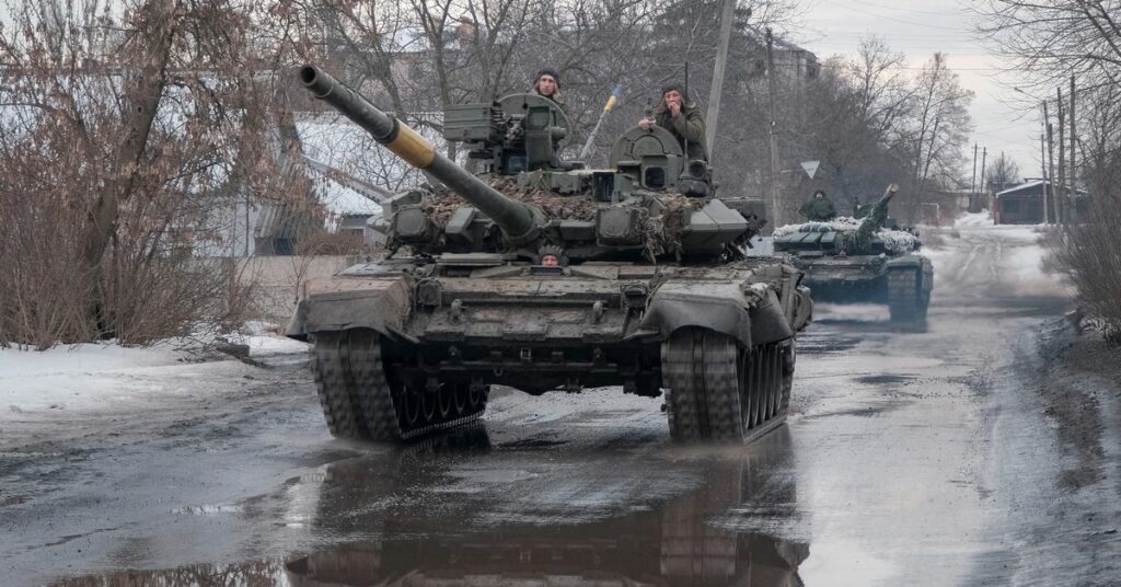 Ukrainian service members ride tanks in Bakhmut