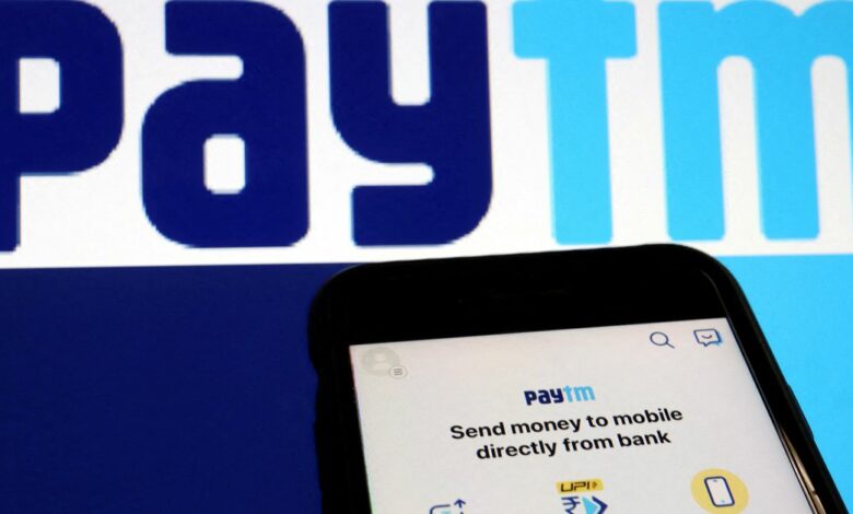 The interface of Indian payments app Paytm is seen in front of its logo displayed in this illustration picture