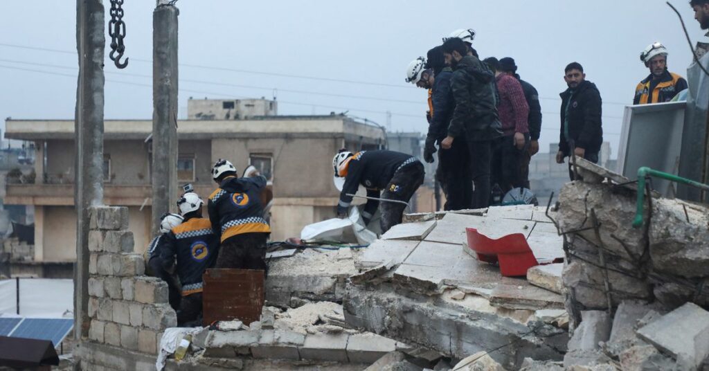 Rescuers search for survivors, following an earthquake, in rebel-held Azaz