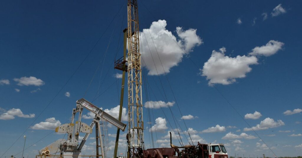 A work over rig performs maintenance on an oil well in the Permian Basin oil production area near Wink