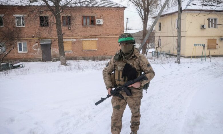A Ukrainian serviceman walks an empty street in Bakhmut
