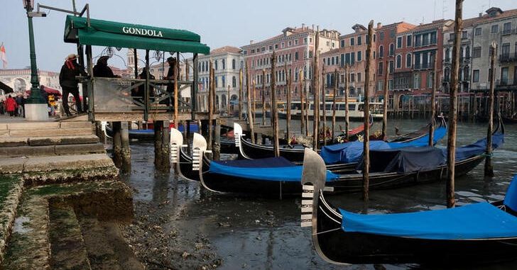 Gondolas are pictured in the Grand Canal during a severe low tide in the lagoon city of Venice