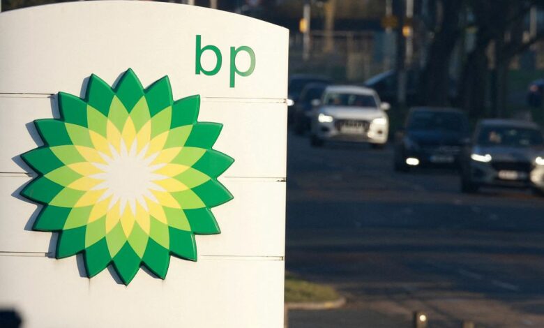 Vehicles drive past a BP (British Petroleum) petrol station in Liverpool