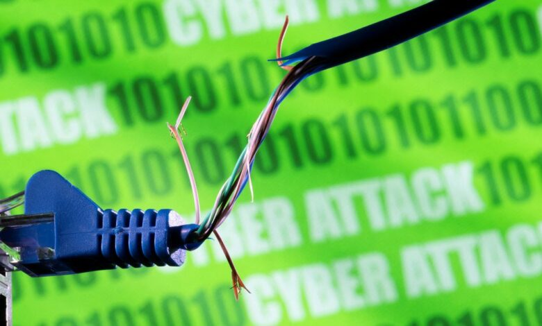Illustration shows broken Ethernet cable, binary code and words "cyber attack