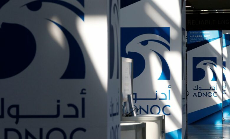 Logos of ADNOC are seen at Gastech, the world's biggest expo for the gas industry, in Chiba