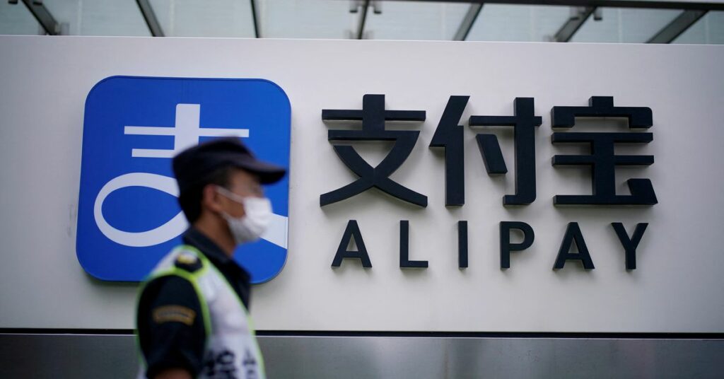 A security guard walks past an Alipay logo at the Shanghai office of Alipay, owned by Ant Group which is an affiliate of Chinese e-commerce giant Alibaba, in Shanghai