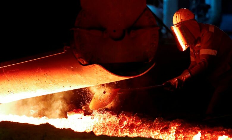 A steel worker of Germany's industrial conglomerate ThyssenKrupp AG works near a blast furnace at Germany's largest steel factory in Duisburg