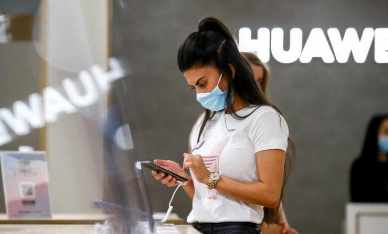 An employee uses a Huawei P40 smartphone at the IFA consumer technology fair, in Berlin