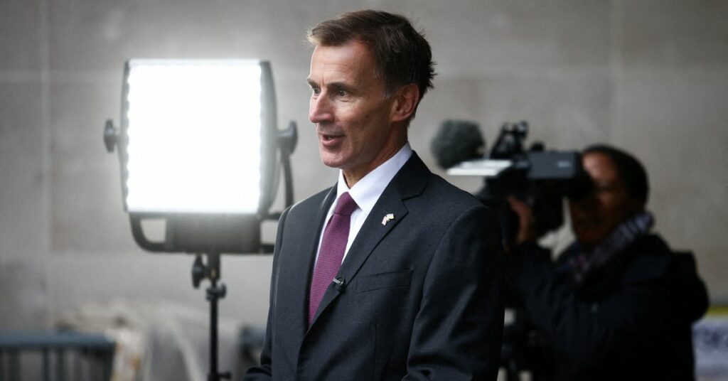 British Chancellor of the Exchequer Jeremy Hunt talks to a television crew outside the BBC headquarters in London