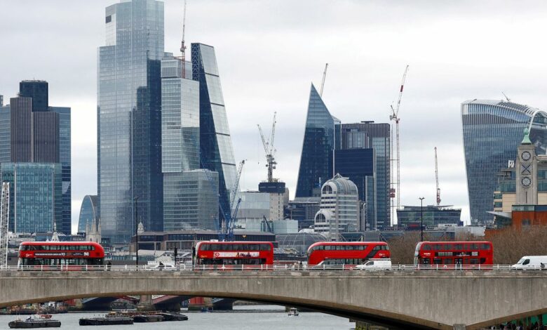 FILE PHOTO: The City of London is seen as buses cross Waterloo Bridge in London