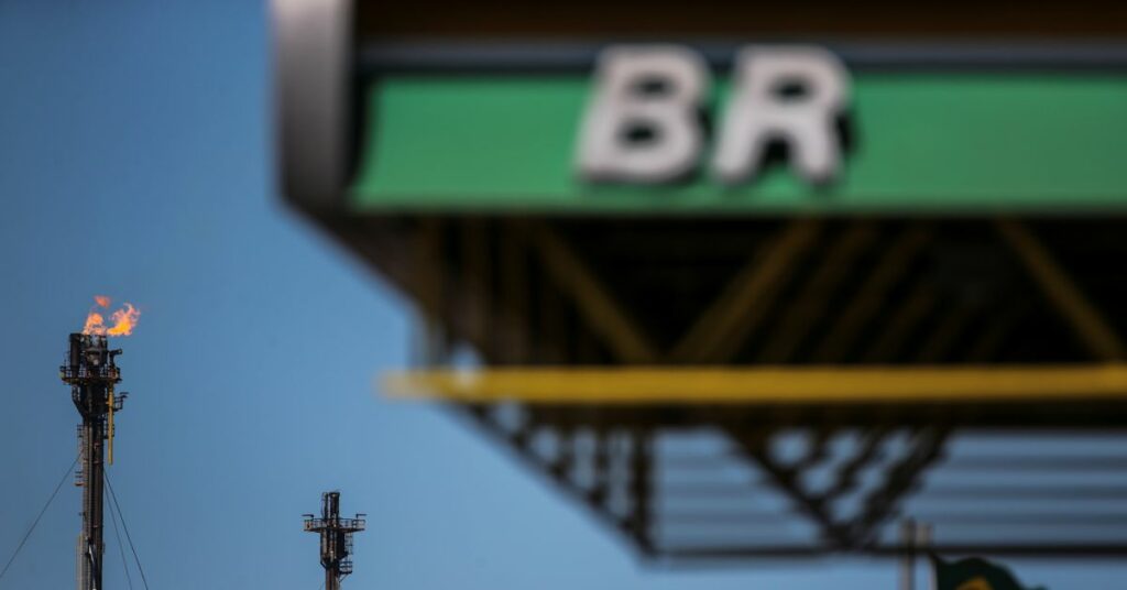 The logo of state-run oil company Petrobras is seen in front of the Brazilian national flag at the Alberto Pasqualini Refinery in Canoas