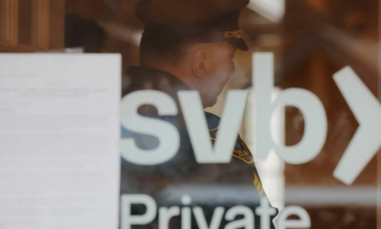 A police officer controls access to a branch of Silicon Valley Bank in Wellesley