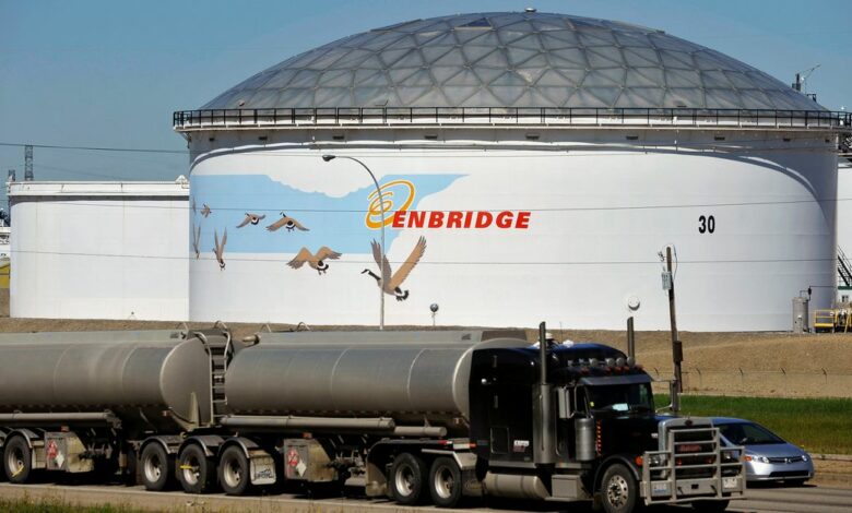 A storage tank looms over a freeway at the Enbridge Edmonton terminal in Edmonton