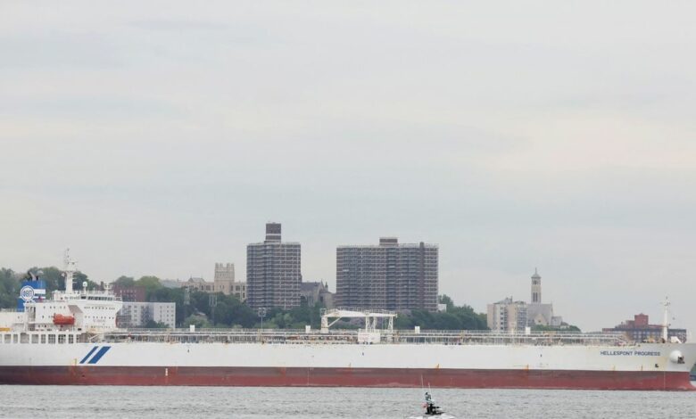 A NYPD boat passes by the Hellespont Progress, an oil tanker anchored in New York Harbor