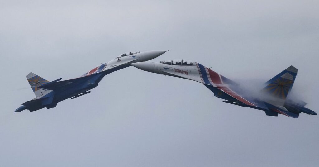 Sukhoi Su-27 Flanker fighters of the Russkiye Vityazi aerobatic display team perform during a demonstration flight at the opening ceremony of the International Army Games in Alabino, outside Moscow, Russia